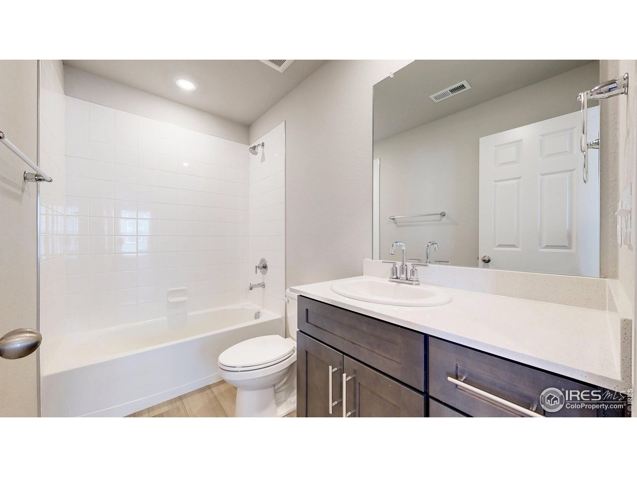 229 East 4th Street Berthoud, CO 80513 - Photo 24 of 49 a bathroom with a sink a toilet and a large mirror