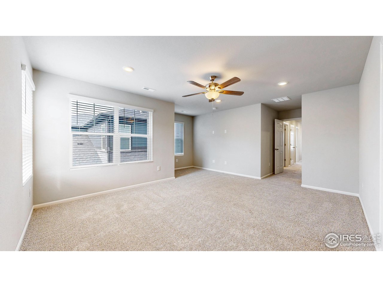 229 East 4th Street Berthoud, CO 80513 - Photo 26 of 49 a living room with a couch and chandelier