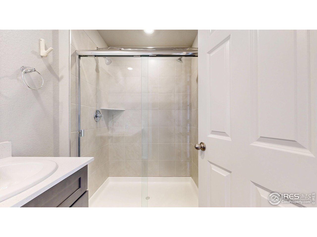 229 East 4th Street Berthoud, CO 80513 - Photo 30 of 49 a bathroom with a sink and a shower