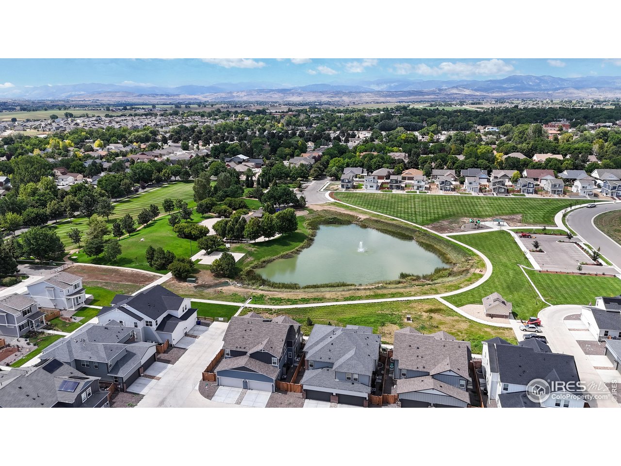 229 East 4th Street Berthoud, CO 80513 - Photo 49 of 49 an aerial view of a house with a swimming pool a yard and mountain view in back