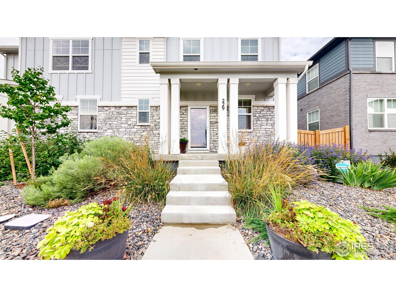 229 East 4th Street Berthoud, CO 80513 - Photo 6 of 49 a view of a house with fountain and potted plants