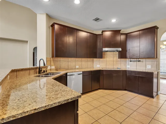 a kitchen with kitchen island granite countertop a sink and counter space