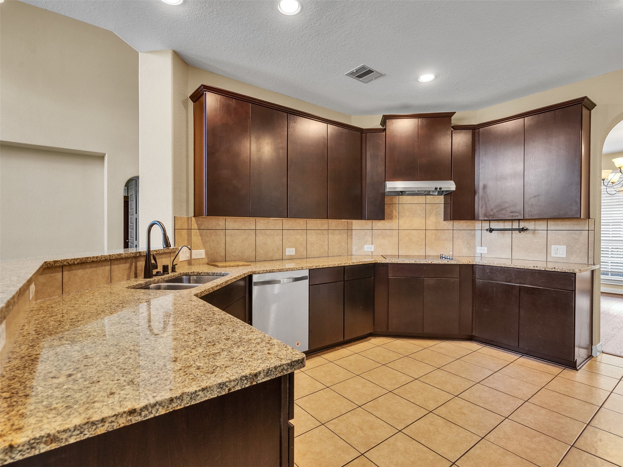 10135 Cypress Path Missouri City, TX 77459 - Photo 18 of 40 a kitchen with kitchen island granite countertop a sink and counter space