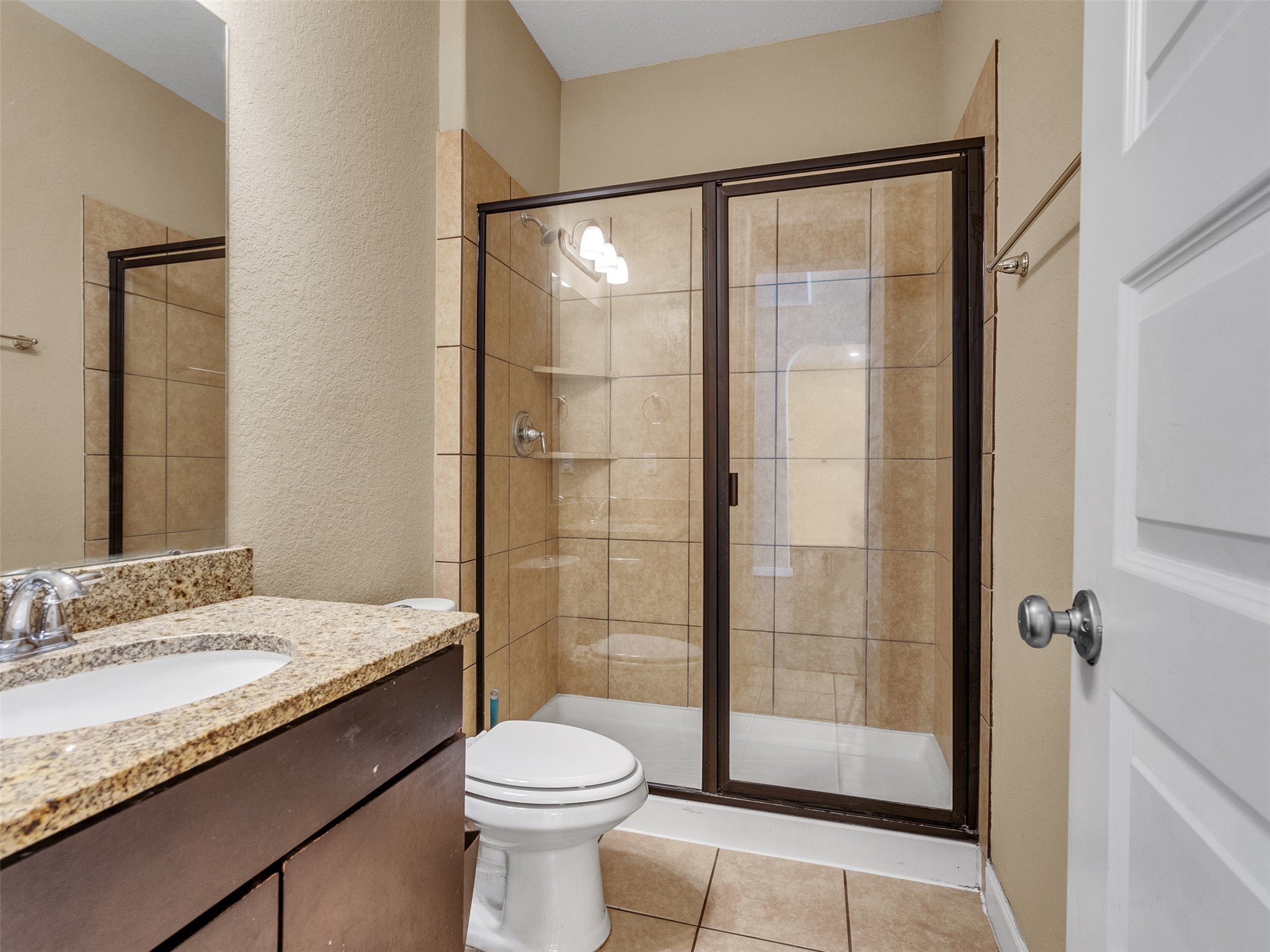 10135 Cypress Path Missouri City, TX 77459 - Photo 8 of 40 a bathroom with a granite countertop sink toilet and shower