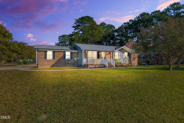 a front view of a house with a garden