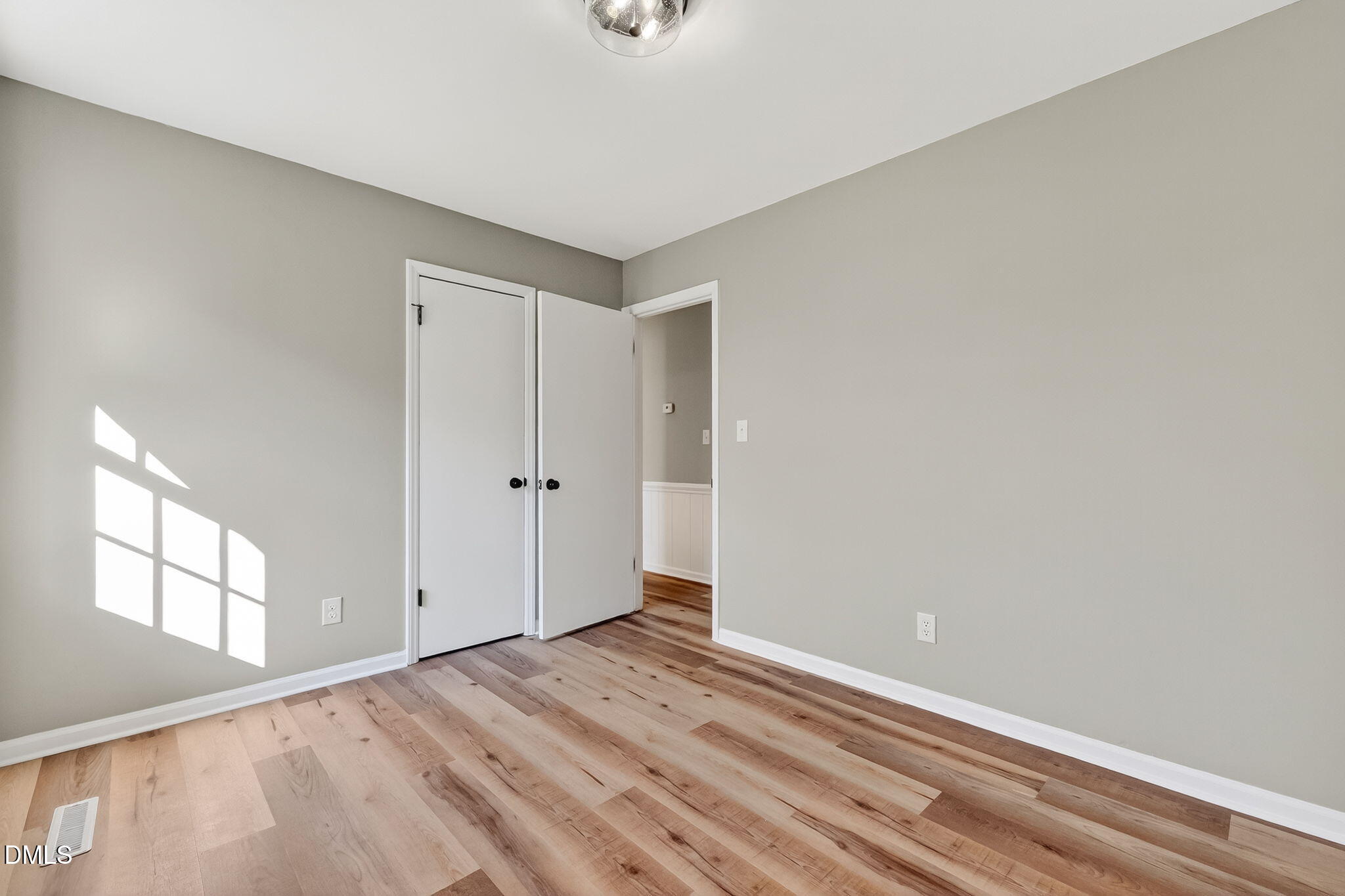505 Pineview Road Kenly, NC 27542 - Photo 19 of 35 a view of an empty room with wooden floor and a window