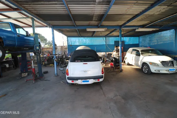 a view of a balcony with car parked on the road