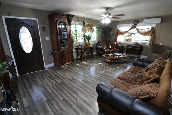 a bedroom with a bed and a flat tv screen on the dresser