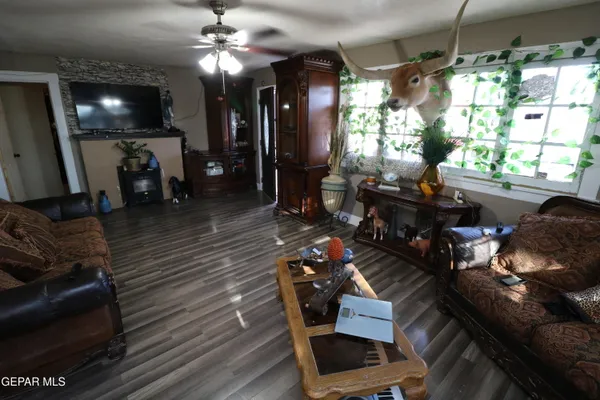 a living room with furniture and wooden floor