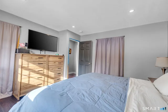 a bedroom with a bed and a night stand