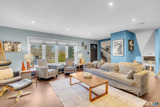 a living room with furniture and a large window