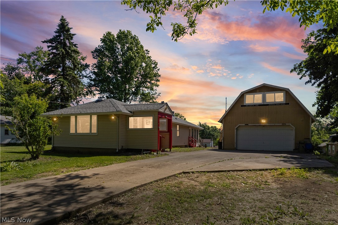 409 Edith Avenue Akron, OH 44312 - Photo 1 of 45 Contemporary single-story residence with light-colored siding, a dark shingle roof, and a red-accented side entrance