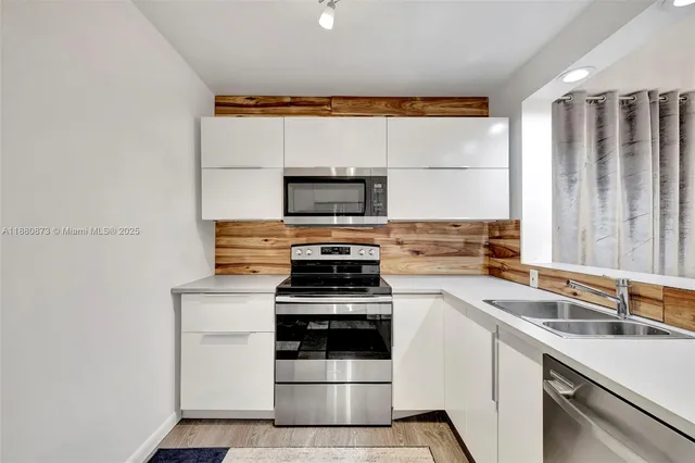 a kitchen with a stove a sink and a microwave