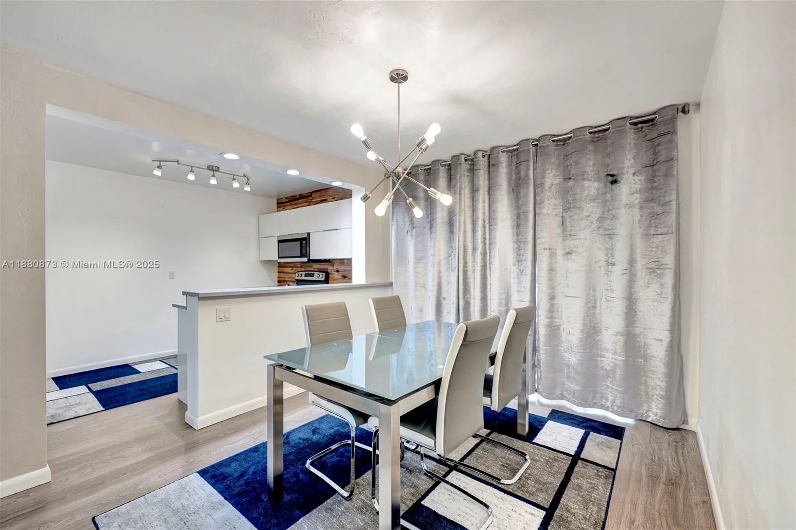 6010 South Falls Cir Drive, Unit 419 Lauderhill, FL 33319 - Photo 15 of 45 a view of kitchen with furniture and a chandelier