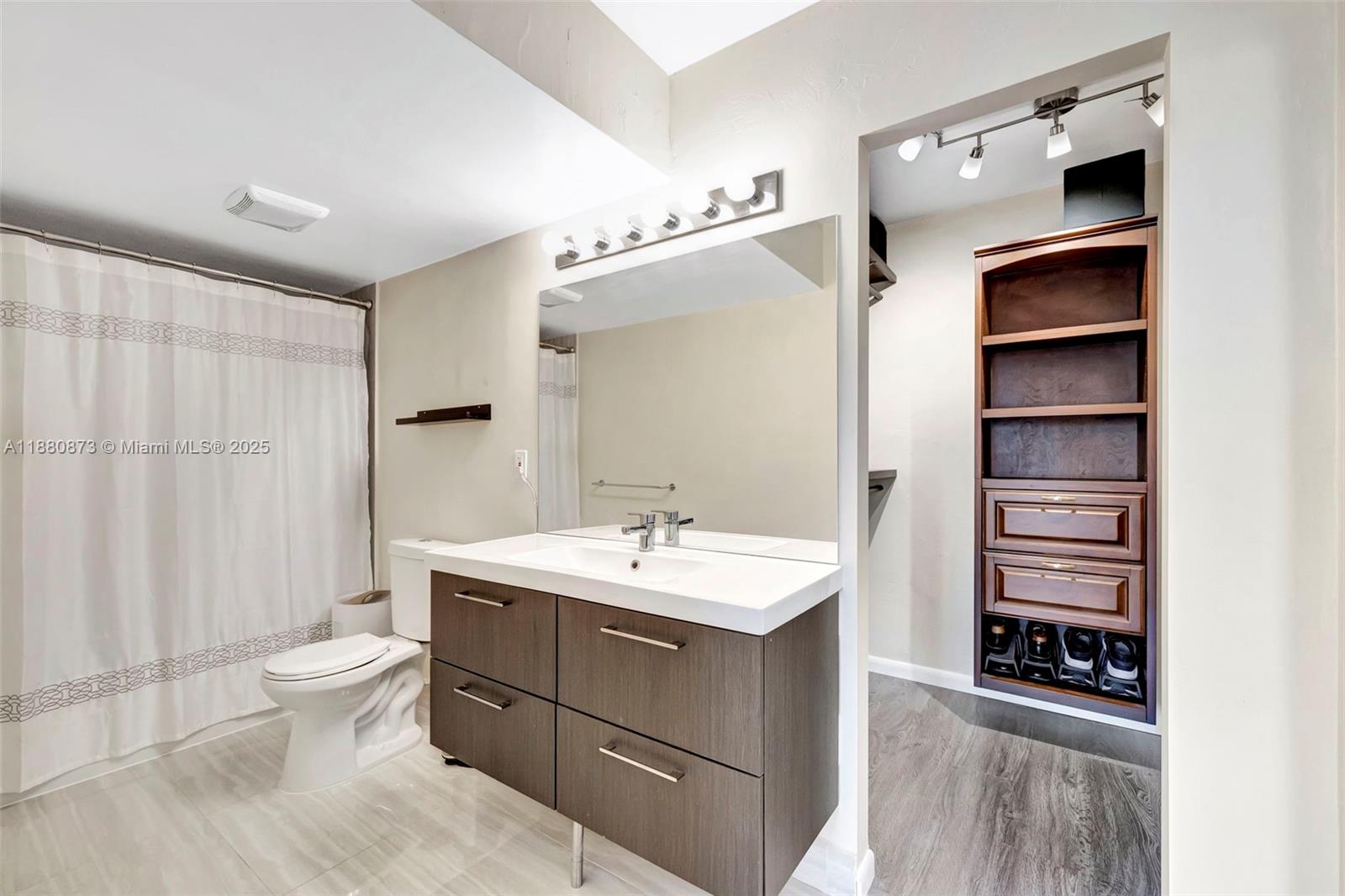 6010 South Falls Cir Drive, Unit 419 Lauderhill, FL 33319 - Photo 19 of 45 a bathroom with a sink a toilet and shower