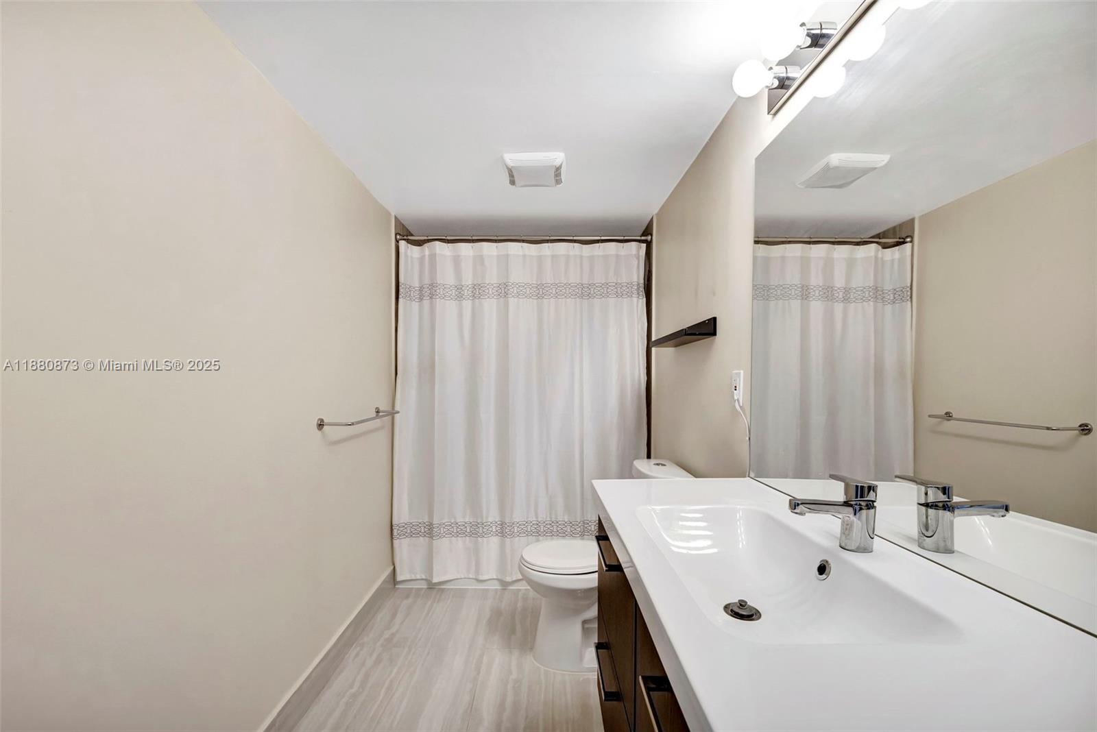 6010 South Falls Cir Drive, Unit 419 Lauderhill, FL 33319 - Photo 20 of 45 a bathroom with a sink a mirror and shower