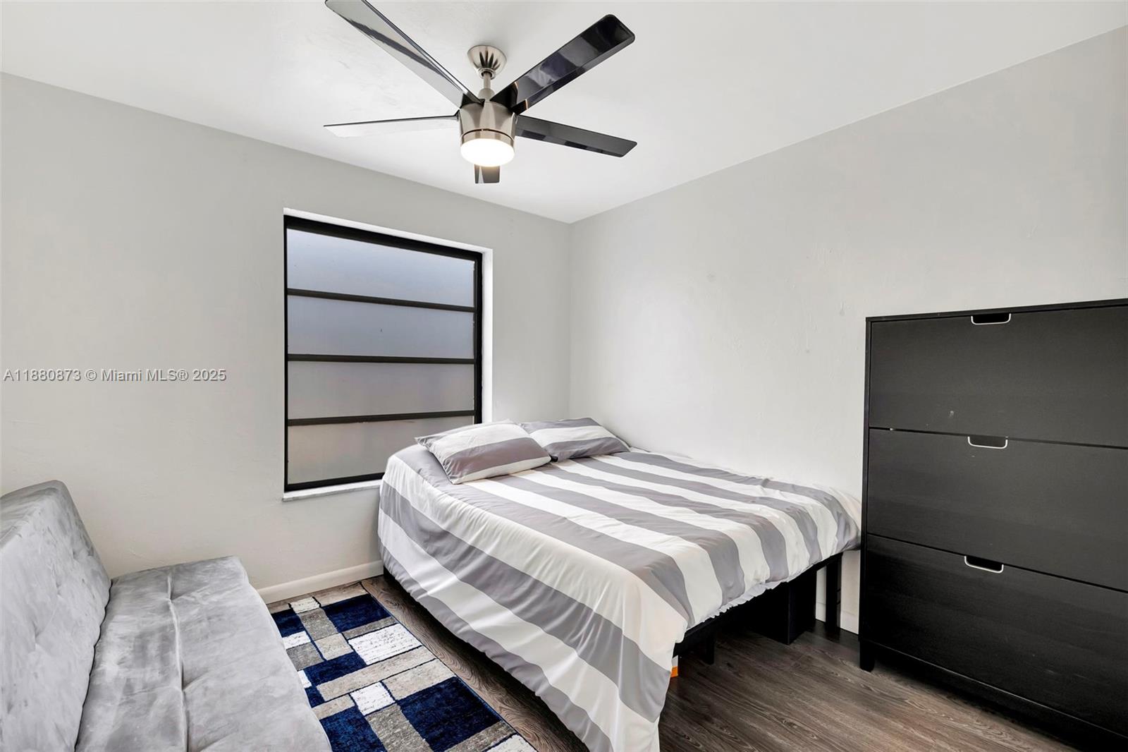 6010 South Falls Cir Drive, Unit 419 Lauderhill, FL 33319 - Photo 21 of 45 a bedroom with a bed and a dresser