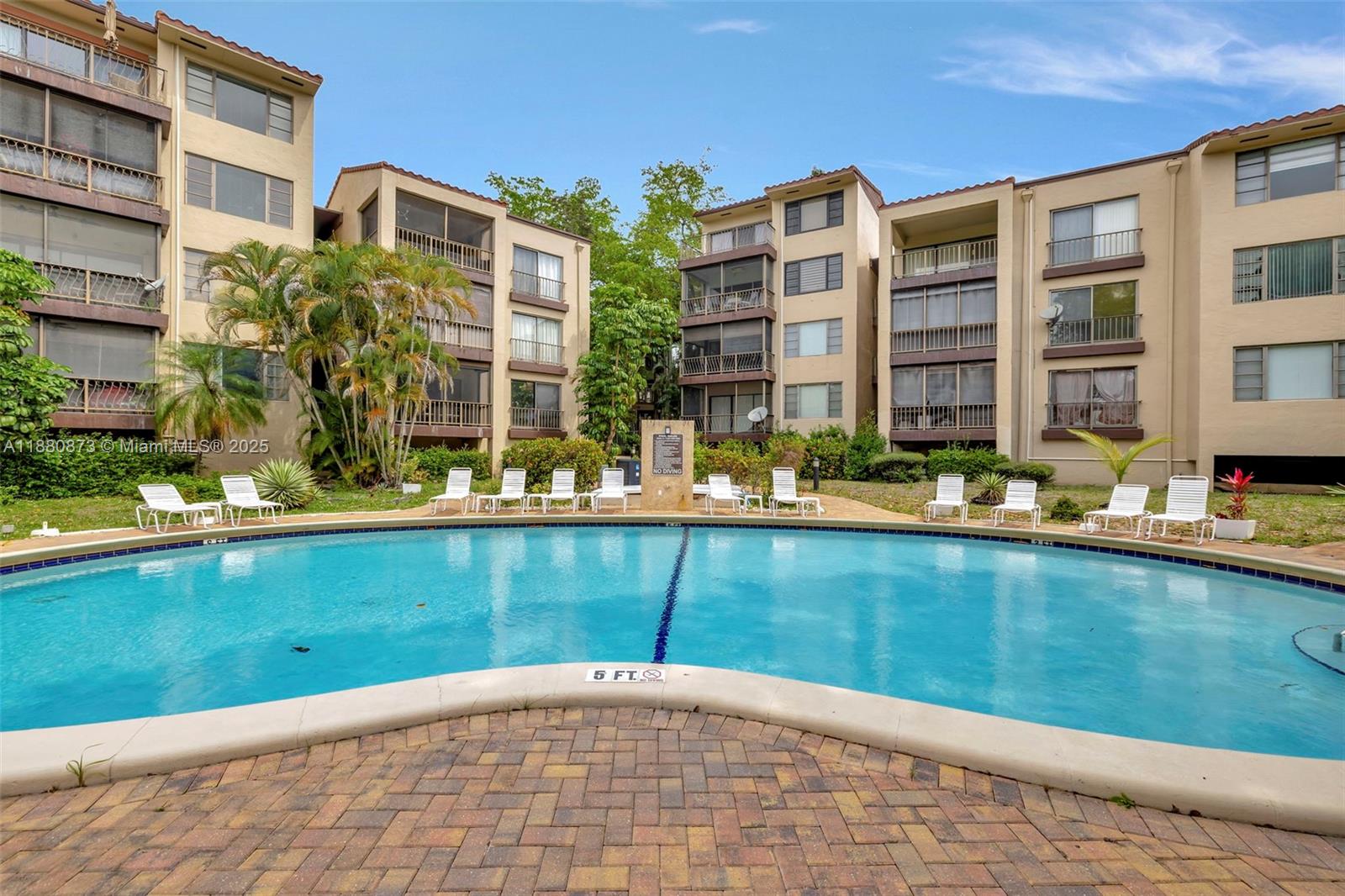 6010 South Falls Cir Drive, Unit 419 Lauderhill, FL 33319 - Photo 25 of 45 a view of a brick building next to a yard