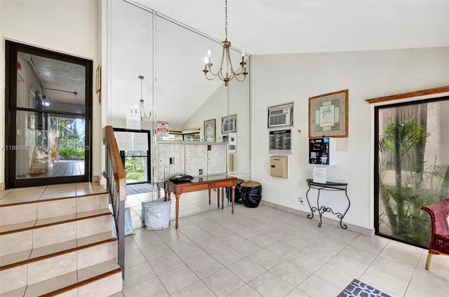 a spacious bedroom with furniture and a chandelier