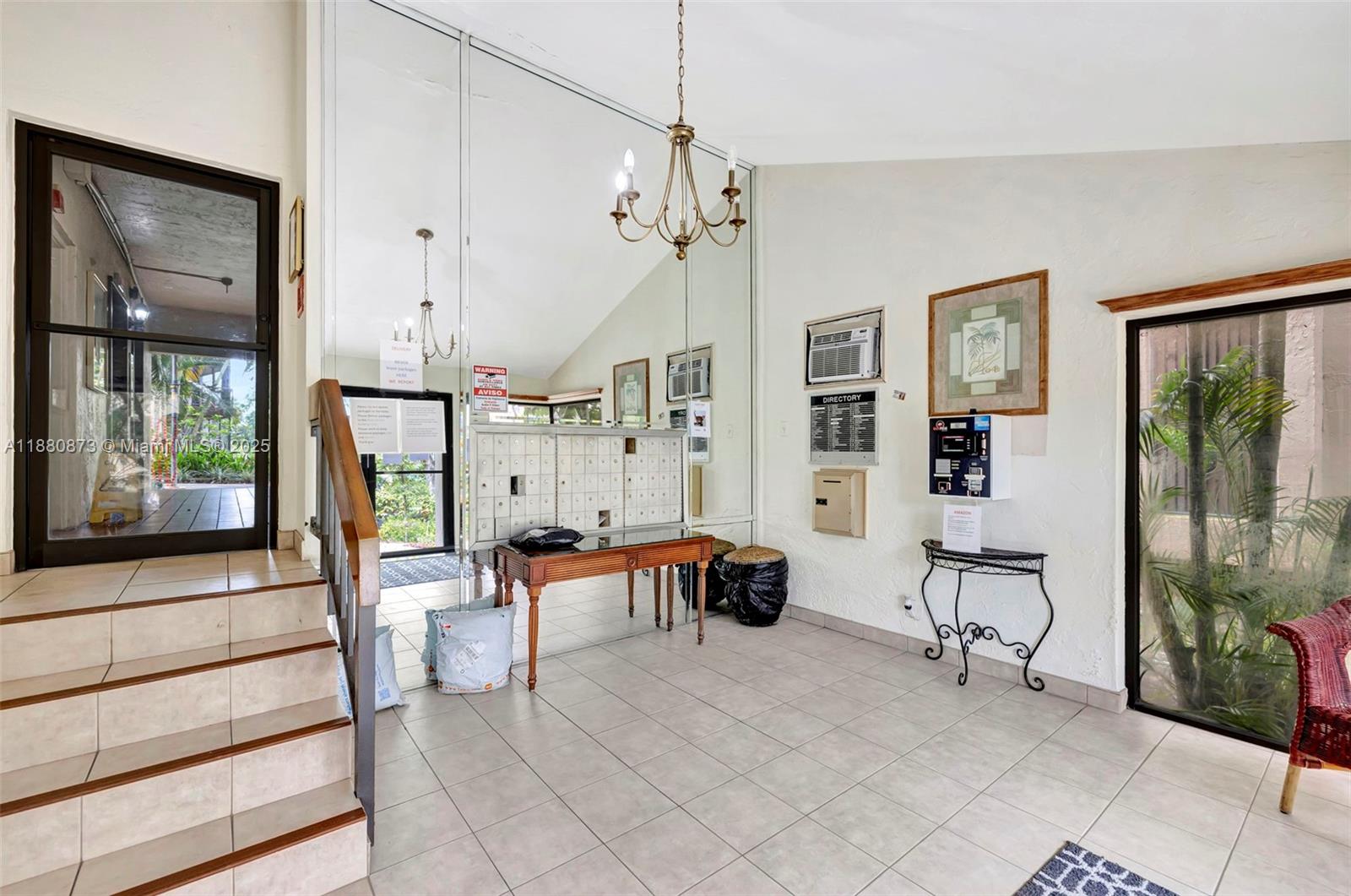 6010 South Falls Cir Drive, Unit 419 Lauderhill, FL 33319 - Photo 27 of 45 a spacious bedroom with furniture and a chandelier