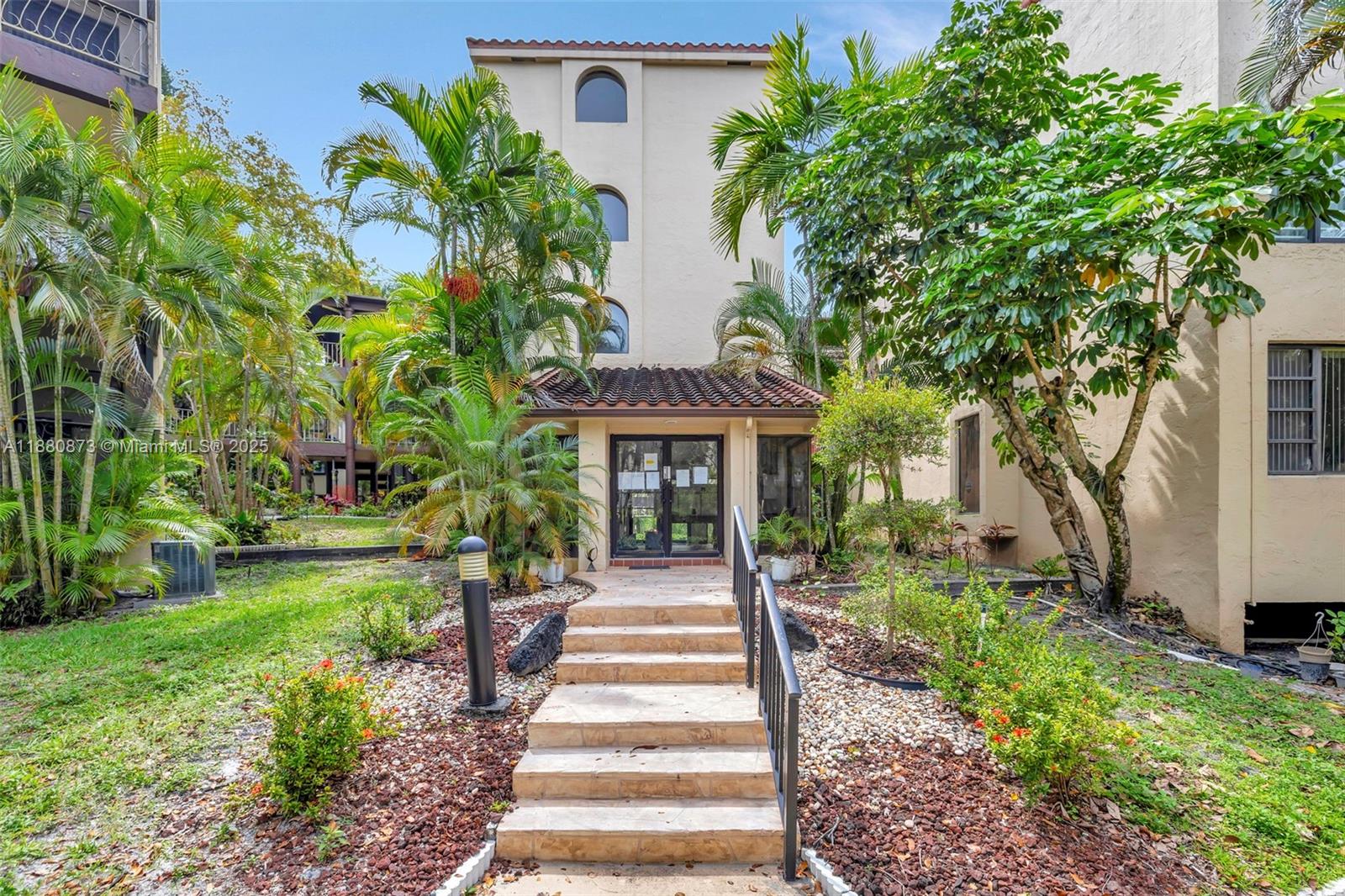 6010 South Falls Cir Drive, Unit 419 Lauderhill, FL 33319 - Photo 30 of 45 a front view of a house with a garden and trees