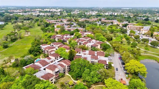 an aerial view of multiple houses with yard