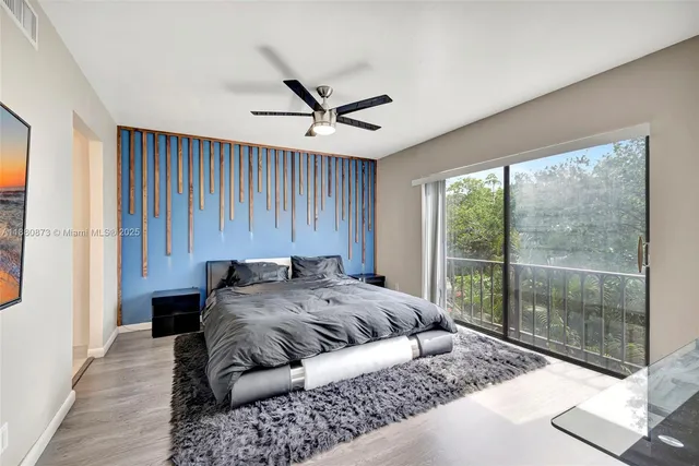 a bed sitting in a spacious bedroom next to a window