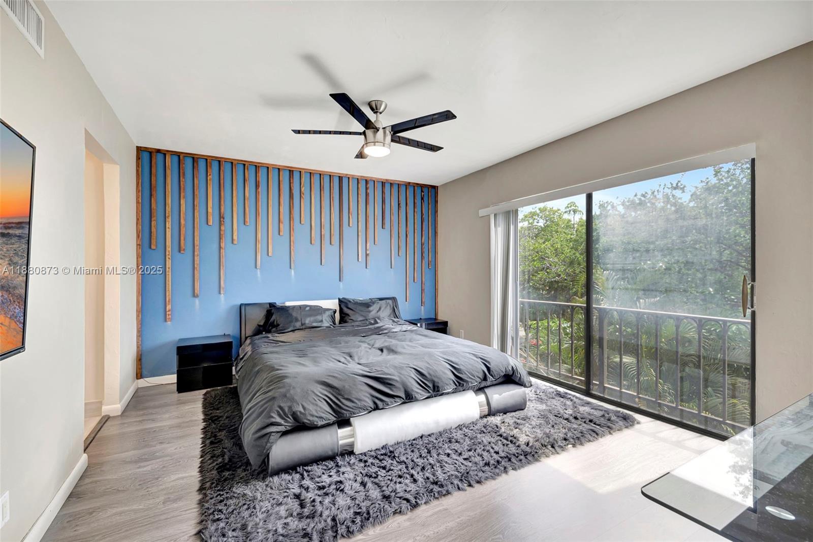 6010 South Falls Cir Drive, Unit 419 Lauderhill, FL 33319 - Photo 4 of 45 a bed sitting in a spacious bedroom next to a window