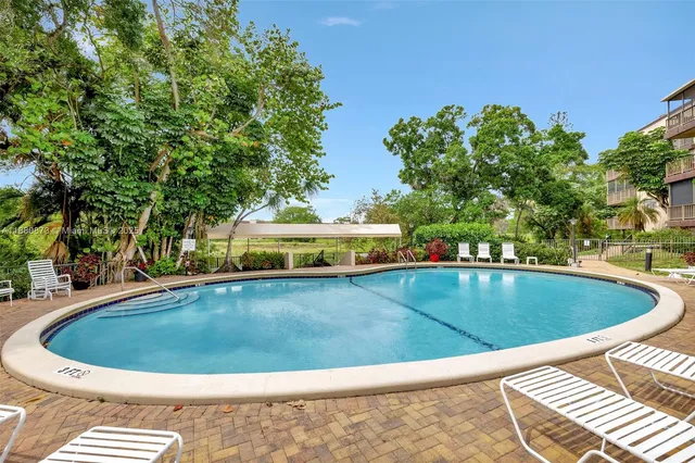 a view of a swimming pool with a yard
