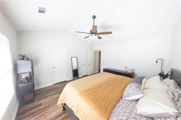 a bedroom with a bed and a chandelier