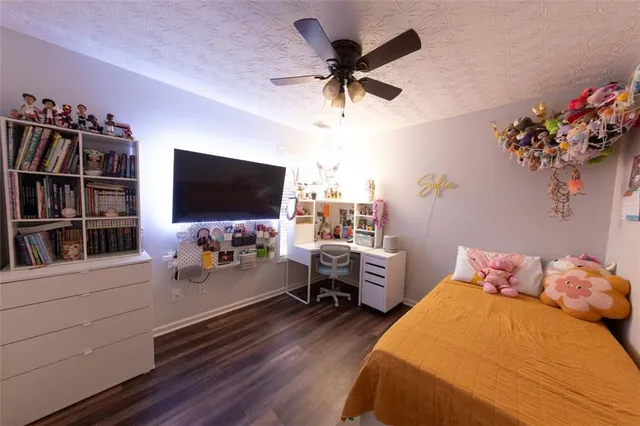 a bedroom with furniture and a flat screen tv
