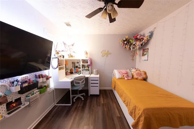 a bedroom with a bed and flat screen tv