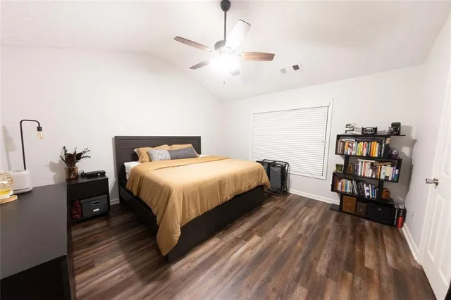 a bedroom with a bed and a book shelf