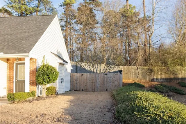 a view of a house with backyard and sitting area