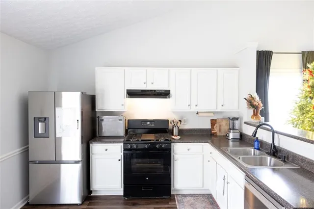a kitchen with a refrigerator stove and sink