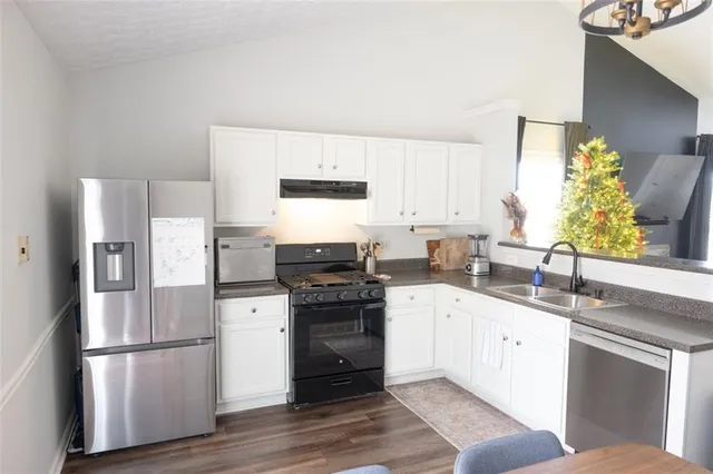 a kitchen with a white cabinets and white appliances