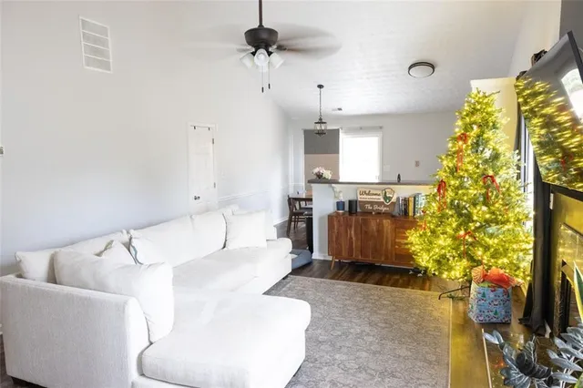 a living room with a couch and a chandelier