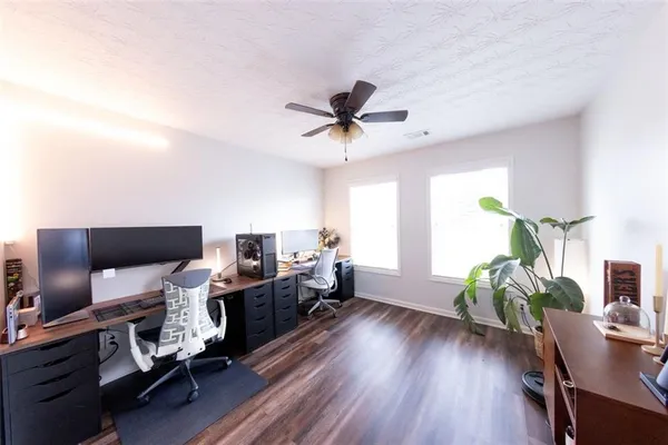 a living room with furniture and a wooden floor