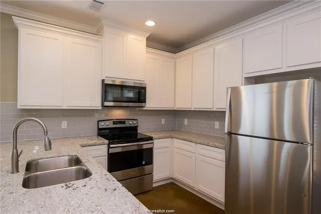 a kitchen with a sink stove and refrigerator