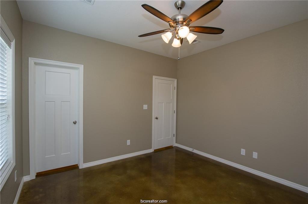 3200 Link Street Bryan, TX 77801 - Photo 8 of 24 an empty room with a chandelier fan and windows