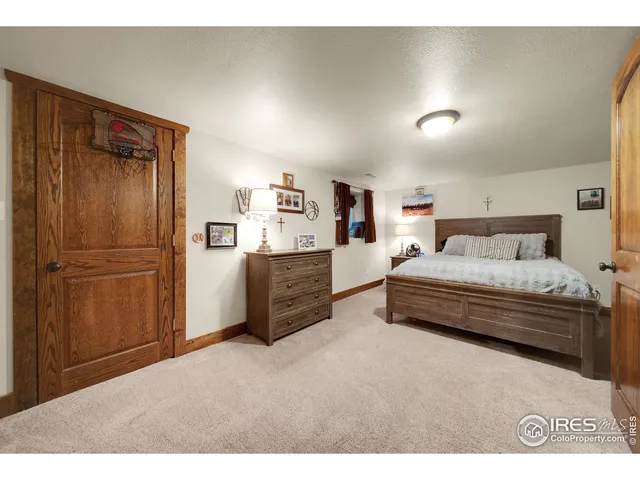 a bedroom with a bed and a refrigerator