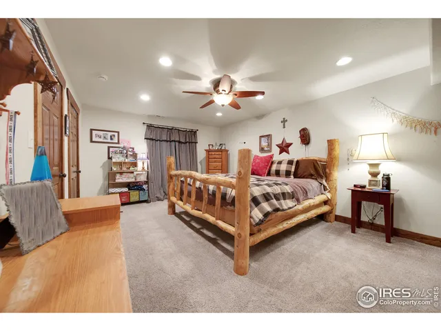 a bedroom with bed and a chandelier