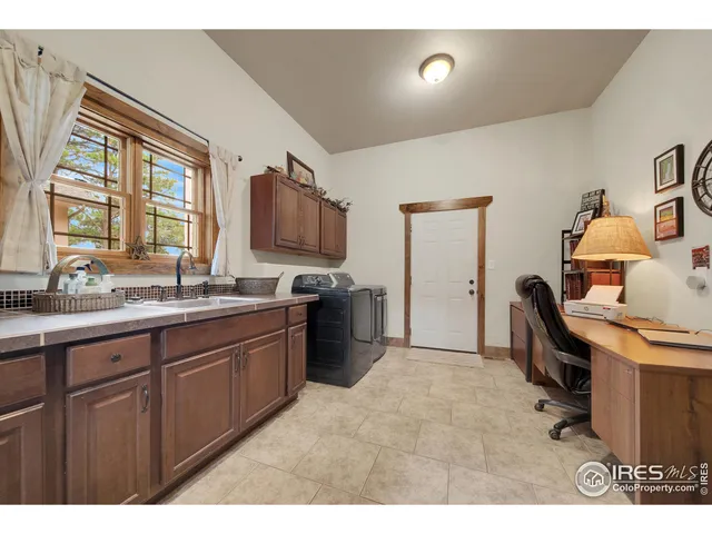 a open kitchen with kitchen island granite countertop a sink and a refrigerator