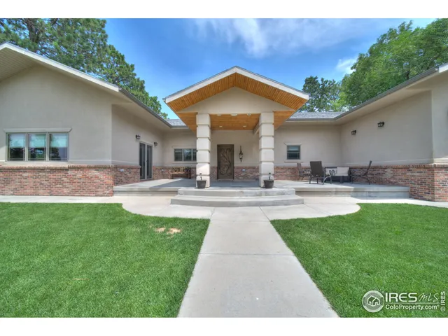 a swimming pool with outdoor seating and yard