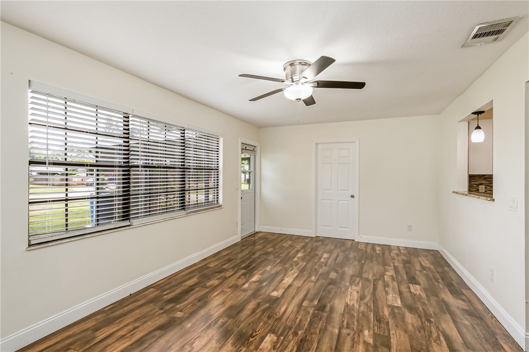 1121 Clearmont Street Sebastian, FL 32958 - Photo 16 of 31 a view of empty room with wooden floor and fan