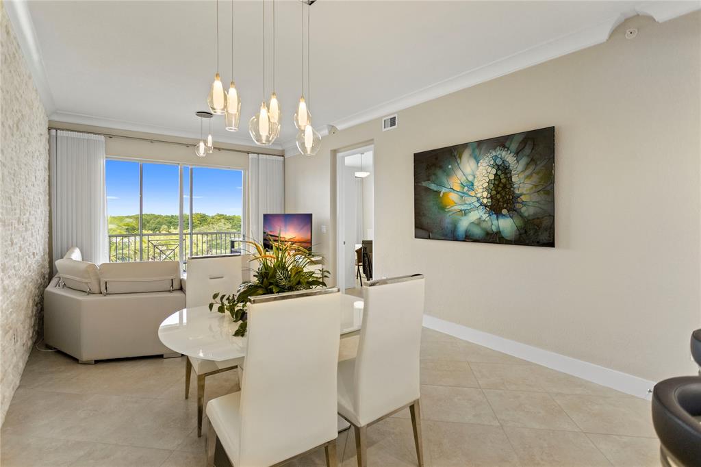 3500 Oaks Clubhouse Drive, Unit 505 Pompano Beach, FL 33069 - Photo 12 of 33 a view of a dining room with furniture window and outside view