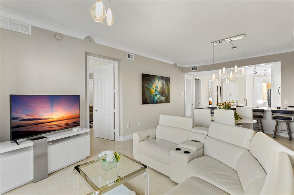 3500 Oaks Clubhouse Drive, Unit 505 Pompano Beach, FL 33069 - Photo 15 of 33 a living room with furniture and a flat screen tv