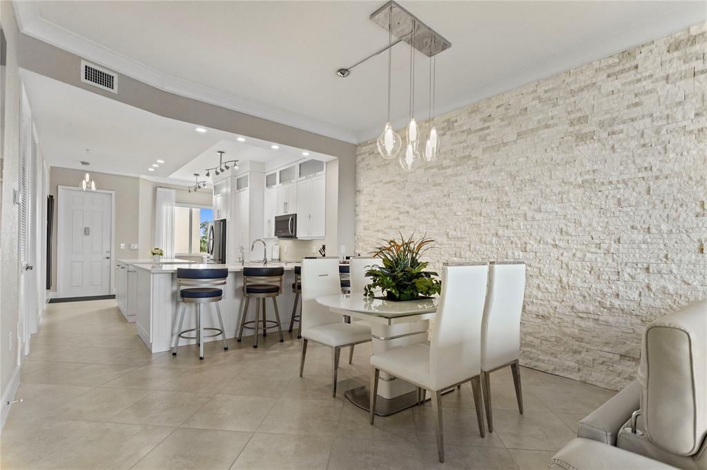 3500 Oaks Clubhouse Drive, Unit 505 Pompano Beach, FL 33069 - Photo 19 of 33 a view of a dining room with furniture