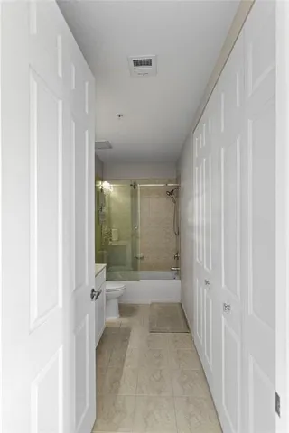 a bathroom with a double vanity sink toilet and shower