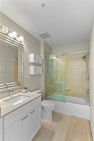 a en suite bathroom with a double vanity sink mirror and bathtub